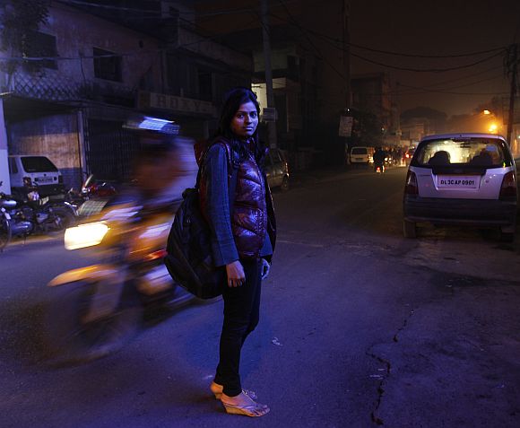 Sheetal, 23, who works at a night call centre, poses for a photograph