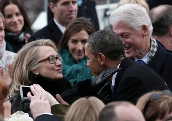 US President Barack Obama greets Secretary of State Hillary Clinton and former president Bill Clinton in Washington, DC