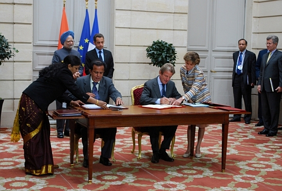 Then ISRO chairman G Madhavan Nair, left, signs an agreement with his French counterpart. Dr Singh and then French president Nicolas Sarkozy can also be seen.