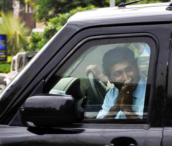 Jailed YSR Congress chief Jaganmohan Reddy greets his supporters as he arrives at the CBI office in Hyderabad