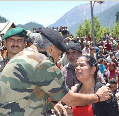 An army officer addresses the concerns of a survivor rescued in Uttarakhand