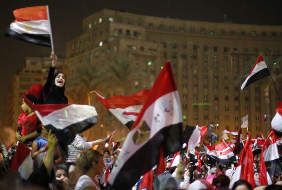 Protesters, who are against Morsi, react in Tahrir Square in Cairo