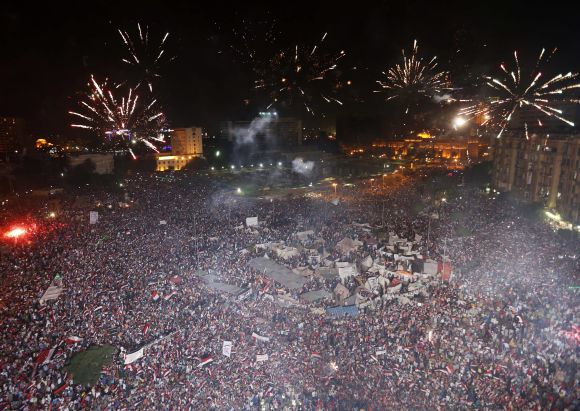 Protesters, who are against Morsi, set-off fireworks as they gather in Tahrir Square in Cairo