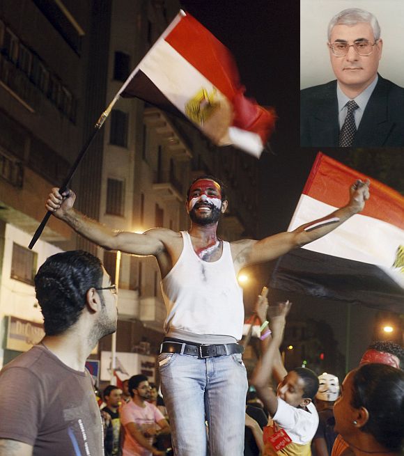 An anti-Mursi protester dances as people celebrate near Tahrir square after the announcement of the removal from office of Egypt's deposed President Mohamed Mursi in Cairo