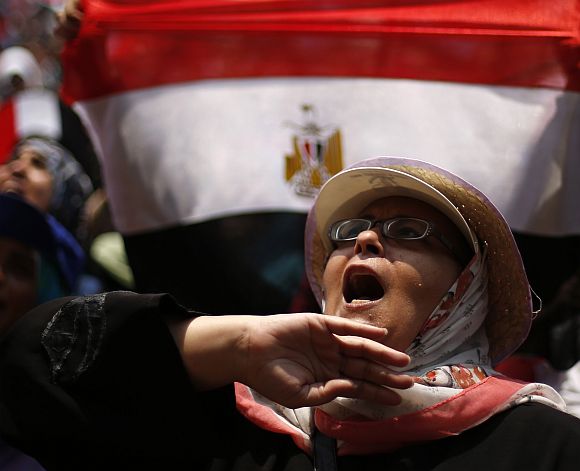 A protester, who is against Egyptian President Mohamed Mursi, shouts as she demonstrates in Tahrir Square in Cairo