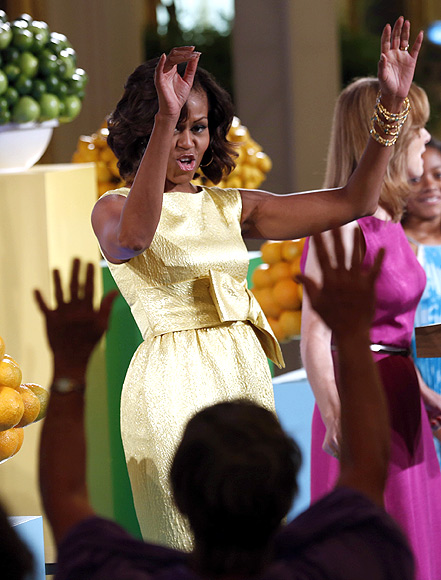 Michelle Obama joins in a wave during the 'kids' state dinner'