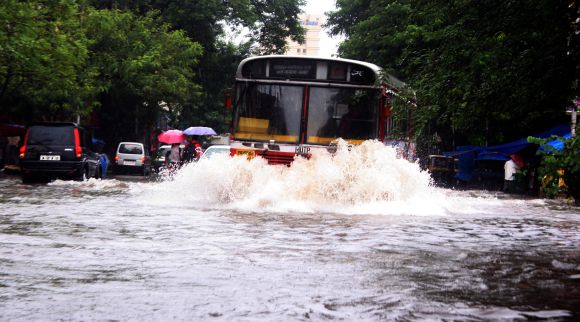 A bus wades through a waterlogged road in Thane on Friday