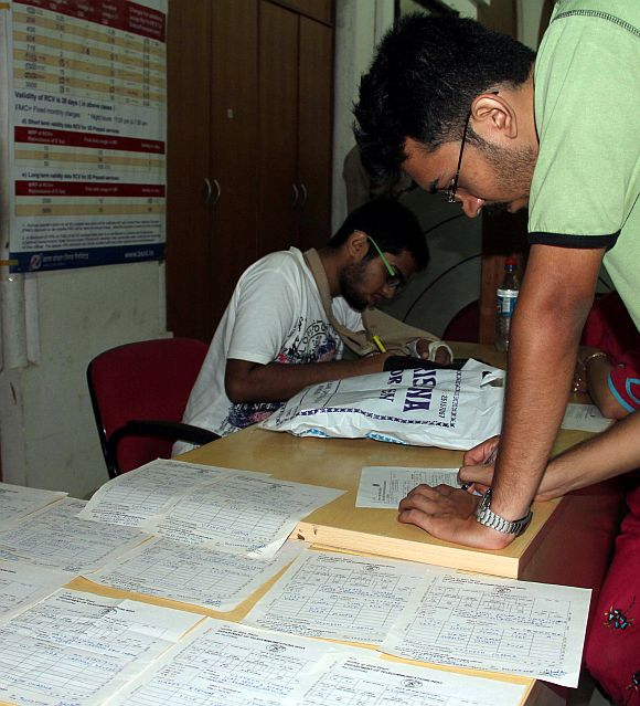 A person fills out his last telegram at a telegraph centre in Mumbai