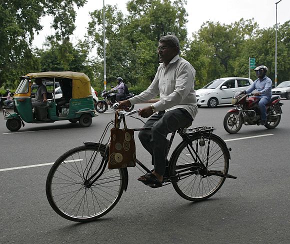 Messenger Om Dutt, 56, rides a bicycle as he delivers telegrams in New Delhi