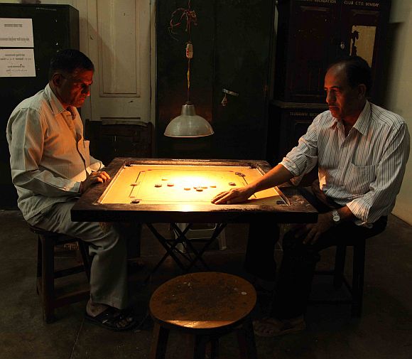 Two operators playing carrom at a telegraph office