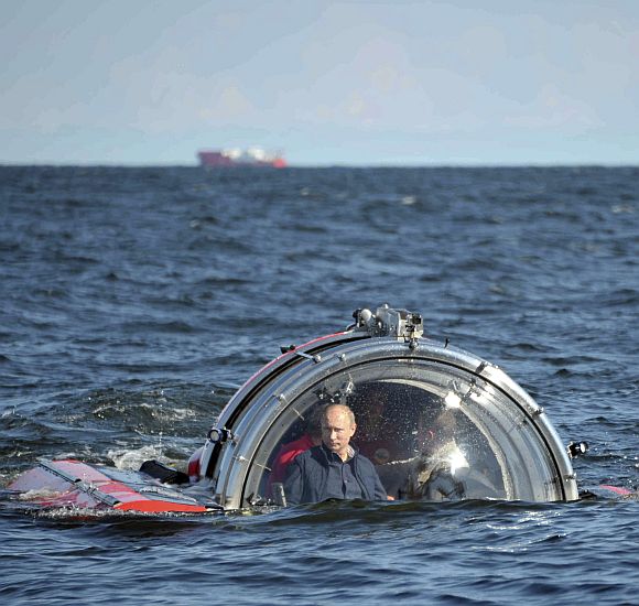 Russia's President Vladimir Putin is seen through the glass of C-Explorer 5 submersible after a dive to see the remains of the naval frigate Oleg, which sank in the 19th century, in the Gulf of Finland in the Baltic Sea July 15