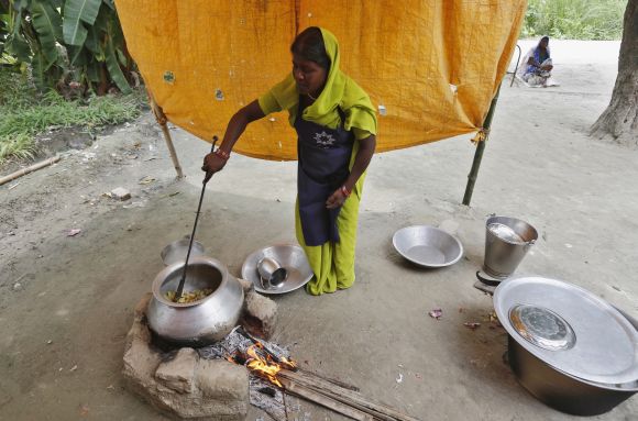 A cook prepares food for the free mid-day meal for children at a school in Bihar