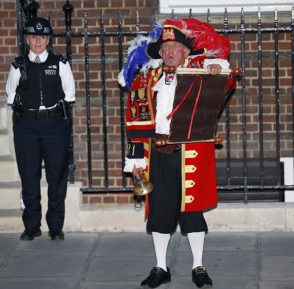 A town crier announces the royal birth outside the Lindo Wing of St Mary's Hospital after Catherine, Duchess of Cambridge gave birth to a baby boy in central London
