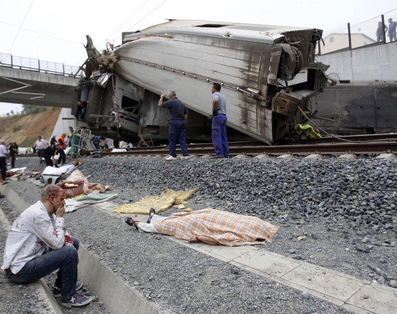  A wounded victim sits near the train crashed site