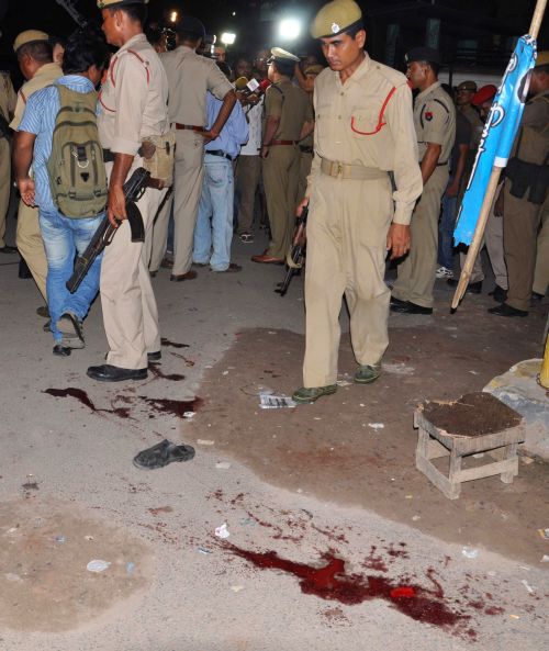 Security personnel inspect the site of the grenade blast near the Guwahati railway station on Sunday