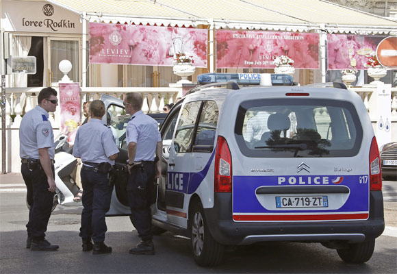 Police officers stand guard outside Carlton hotel in Cannes 