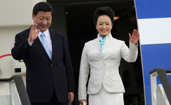 Chinese President Xi Jinping and First Lady Peng Liyuan wave from their plane upon their arrival in Dar es Salaam.