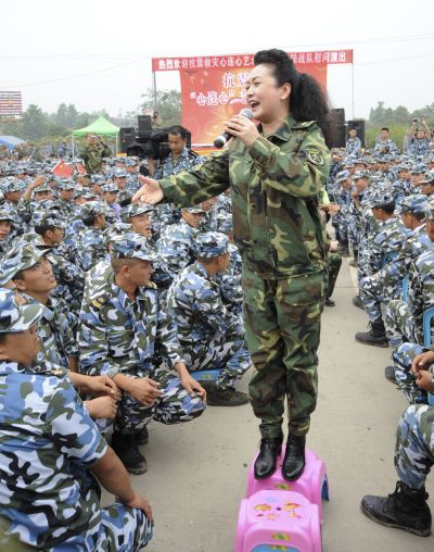 Peng Liyuan sings during a performance as she visits soldiers after the 2008 Wenchuan earthquake in Deyang, Sichuan province