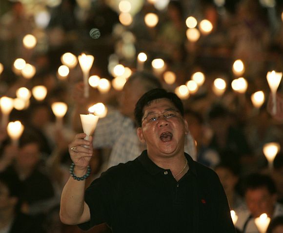 Protesters sing as they take part in a candlelight vigil at Hong Kong's Victoria Park