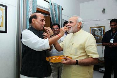 BJP president Rajnath Singh congratulates Gujarat CM Narendra Modi following bypoll victory