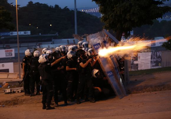 Riot police use tear gas to disperse the crowd during an anti-government protest in Istanbul