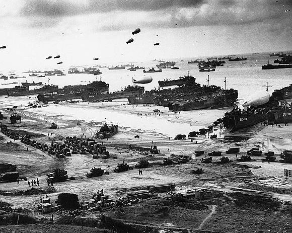 Landing ships putting cargo ashore on one of the invasion beaches, at low tide during the first days of the operation, June 1944.