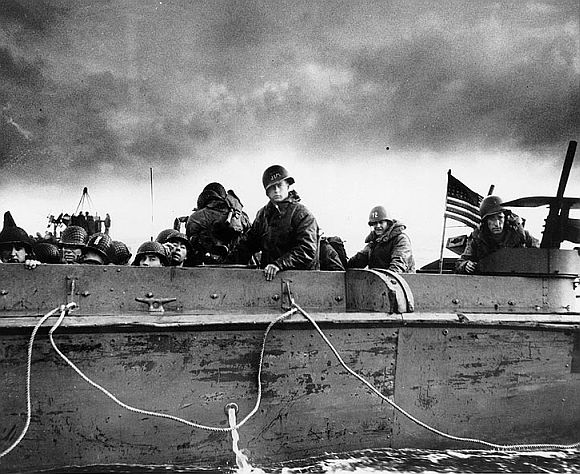 Troops and crewmen aboard a Coast Guard manned LCVP as it approaches a Normandy beach on D-Day