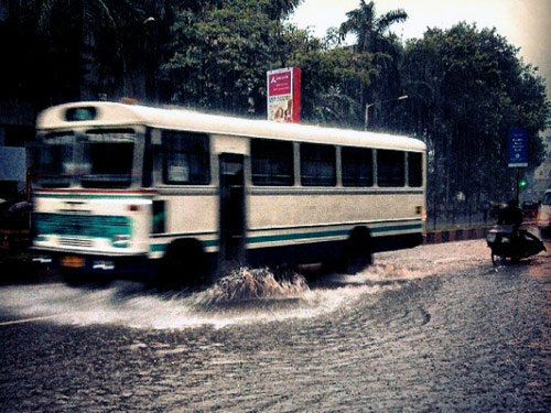 Vehicles wade through a water-logged road in Bandra