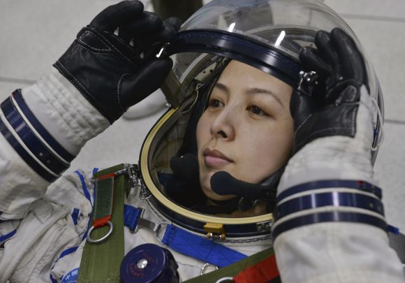 Chinese astronaut Wang Yaping adjusts her helmet during a training at Beijing Aerospace City