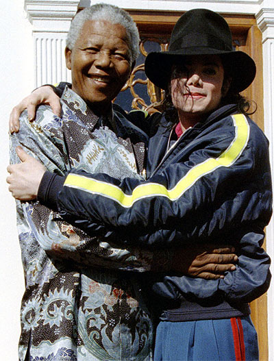 Nelson Mandela and pop star Michael Jackson hug each other at the president's official home in Capetown in this July 20, 1996 file photo