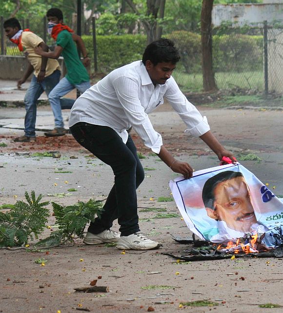 A protestor burning a poster of Andhra Pradesh Chief Minister Kiran Kumar Reddy