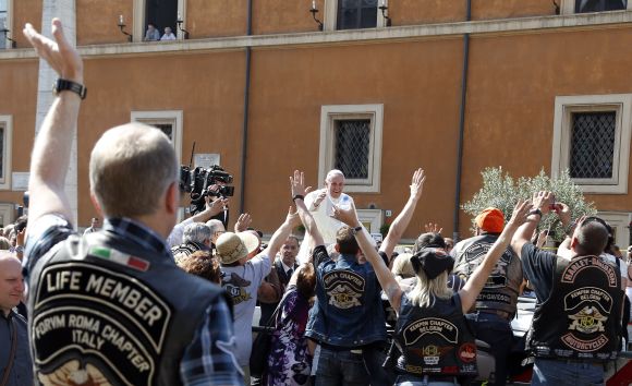 Pope Francis blesses the Harley Davidson bikers from his Popemobile before the start of a mass outside Saint Peter's Square in Rome