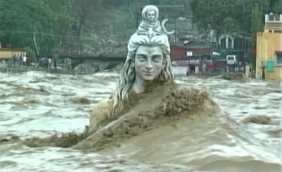 Huge waves of River Ganga crash over the statue of Lord Shiva in Rishikesh