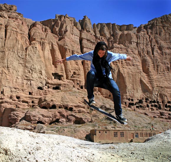 Skateistan volunteer Erika ollies in front of the destroyed Buddhas of Bamiyan, which were built in the 6th century but blown up by the Taliban in 2001