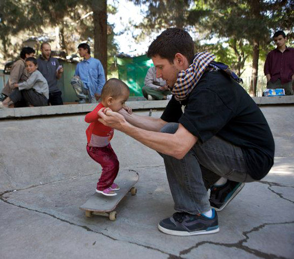 Skateistan's founder and executive director Oliver Percovich with possibly the youngest girl skateboarder in Afghanistan