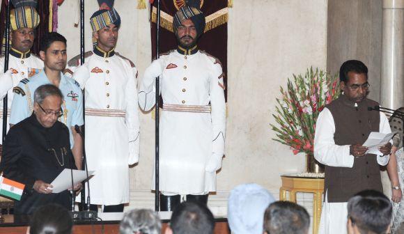 President Pranab Mukherjee administering the oath as Minister of State to Jesudasu Seelam in Rashtrapati Bhavan on Monday.