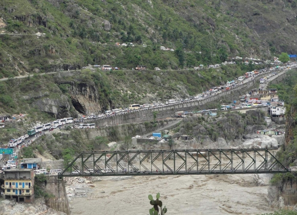 Stranded vehicles stand in queues after heavy rains in the Himalayan state