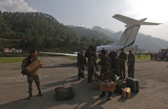 Indian Army paratroopers arrive to help in rescue operations at an airfield in Gauchar