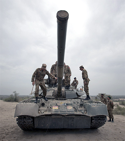 Top Pakistan Army officials climb atop a tank during military exercises in the Khudai Range in central Punjab's Muzaffargarh district