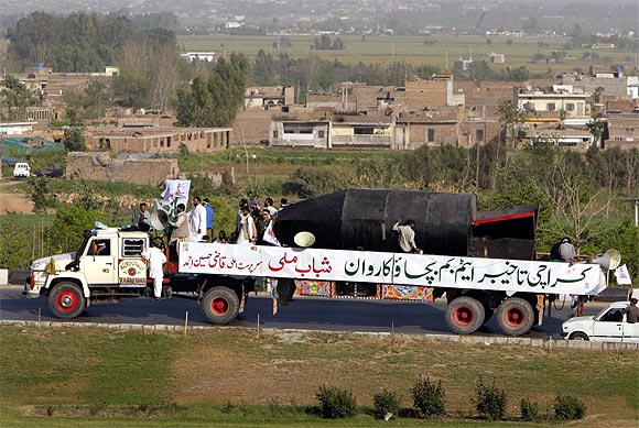 Members of the fundamentalist youth organisation Shabab-e-Milli drive a truck carrying a mock nuclear bomb through Islamabad