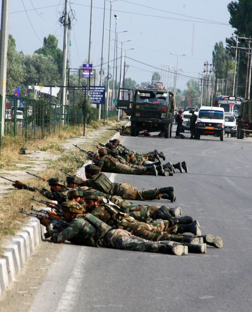 Army personnel talking positions after a militant strike on a convoy outside Srinagar on Monday