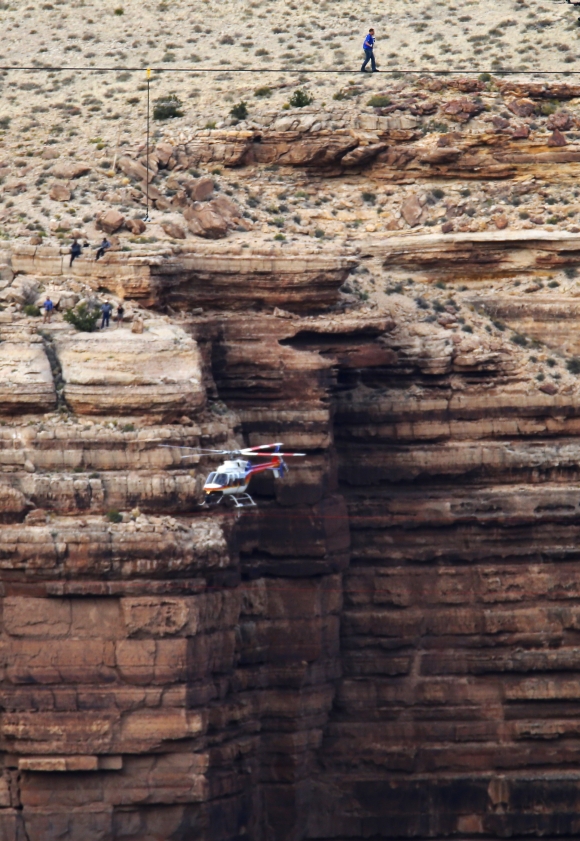 Daredevil Nik Wallenda walks on a two-inch diameter steel cable rigged across more than a quarter-mile deep remote section of the Grand Canyon near Little Colorado River, Arizona