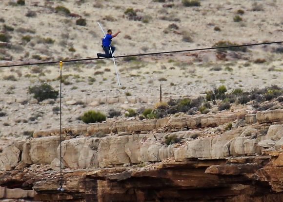 Wallenda gives a thumbs-up sign as he nears the end, after walking across the Grand Canyon