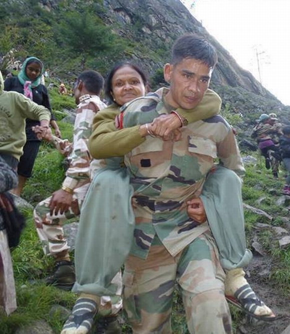 An Indian army personnel rescues a stranded pilgrim in Uttarakhand 