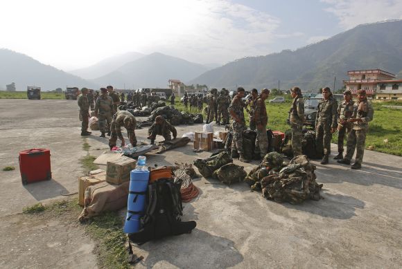 Indian Army Paratroopers prepare to leave for rescue operations at an airfield in Gauchar in Uttarakhand 