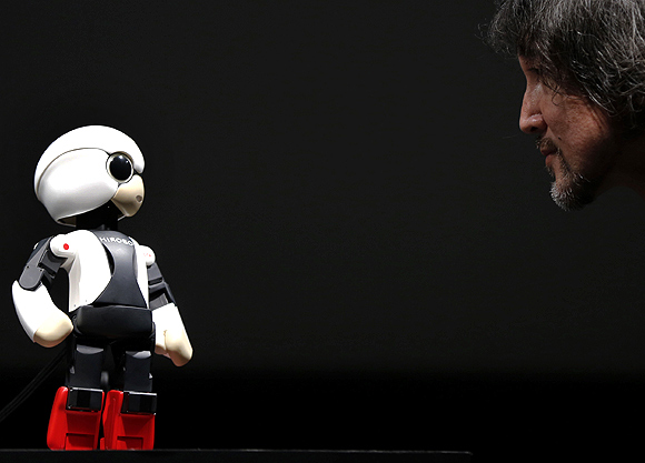 Kirobo talks to Fuminori Kataoka, project general manager in the Product Planning Group of Toyota Motor Corp, during its unveiling in Tokyo