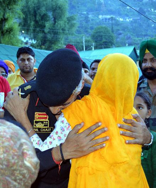 A survivor shows her gratitude to the men in uniform in Uttarakhand