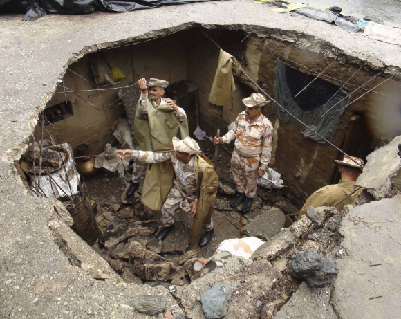 Indo-Tibetan Border Police personnel search for flood victims in a damaged house in Uttarkashi, Uttarakhand