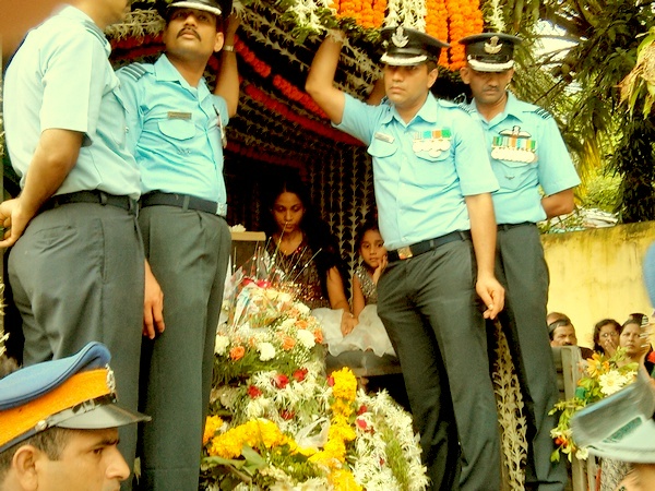 Wing Commander Daryl Castelino's wife Jyothi accompanies her late husband's coffin.