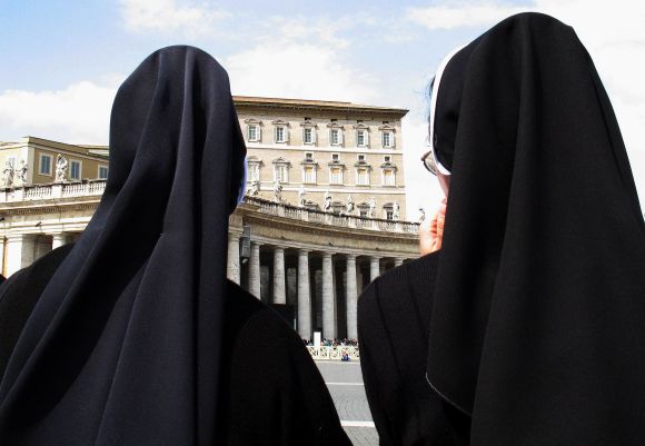 Nuns look towards the Apostolic Palace in Saint Peter's Square